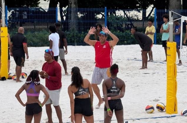 Brazilian volleyball coach Paulo Roberto Moreria da Costa (red vest) looks to congratulate a participant during a beach volleyball development camp at Courland Beach Sports Arena, Black Rock, Tobago last week. - Photo courtesy TTOC