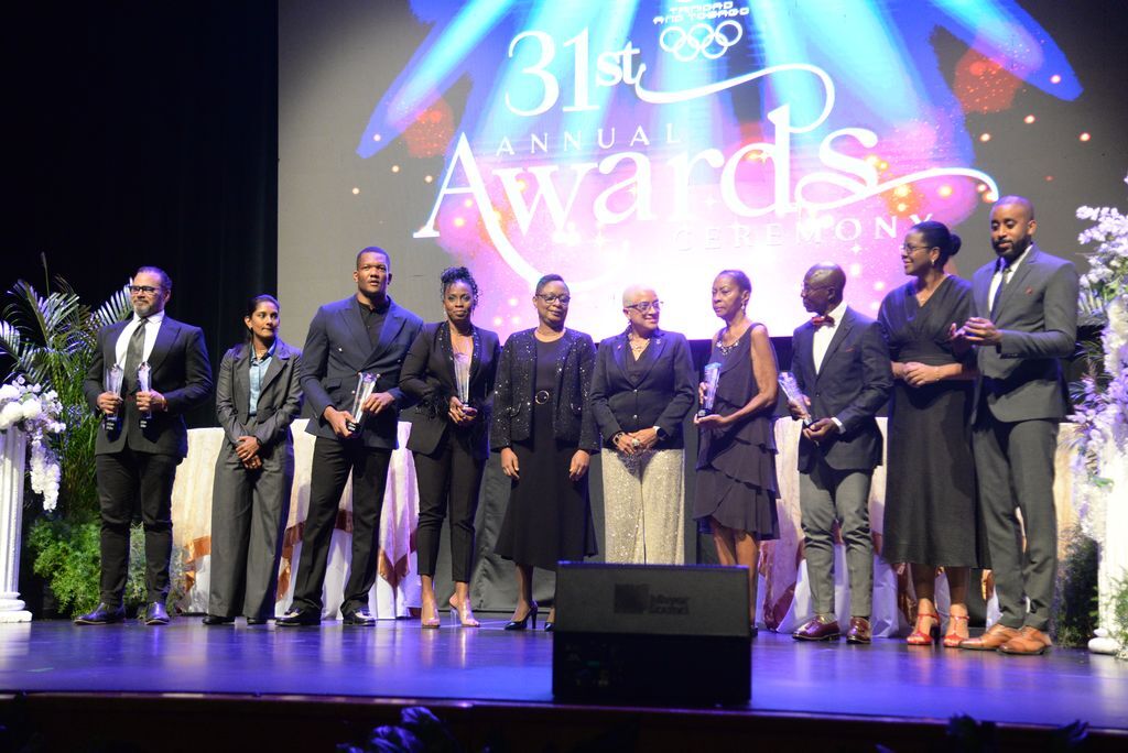 T&T Olympic Committee “Sportsman of the Year” Keshorn Walcott, third from left, poses with fellow awardees, representatives of the athletes who were absent and officials at the TTOC’s 31st awards ceremony at Queen’s Hall, St Ann’s, Port-of-Spain, yesterday. They are Michael Phillips, from left, (collects on behalf of Makaira Wallace, Junior Sportswoman of the Year and People’s Choice awards), feature speaker Karishma Ramharack, Sportsman of the Year” Keshorn Walcott, Brittany Richards-Nelson, Ministry of Sport and Youth Affairs permanent secretary Penelope Bradshaw-Niles, TTOC president Diane Henderson, recipient of the Alex B Chapman award Joyce Walker-Thomas, Wendell Wallace (collected on behalf of Junior Sportsman of the Year), Beverly Reid-Samuel, Ministry of Sport and Youth Affairs permanent secretary and Jehue Gordon (collected on behalf of Future Is Female awardee Shaniqua Bascombe).  ANISTO ALVES (Image obtained at guardian.co.tt)