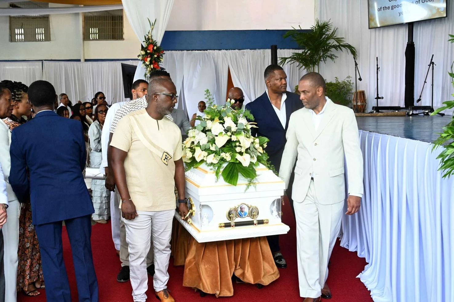FINAL JOURNEY: Family members escort the casket of Sean Roach, at the funeral service at Himalaya Club, San Juan, yesterday. —Photos: ISHMAEL SALANDY (Image obtained at trinidadexpress.com)